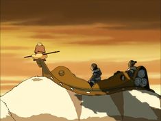 two people are riding on a sled in the sky with mountains and clouds behind them