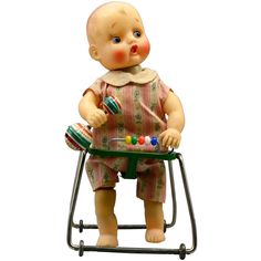 a baby doll sitting on top of a chair