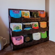 a wooden shelf filled with lots of different types of teas and coffee bags on top of it