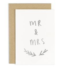 a white card with the words mr and mrs printed in grey ink on top of it