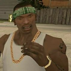 the man is wearing a green headband and holding a gold chain around his neck