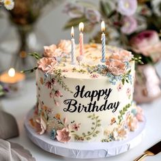 a birthday cake sitting on top of a table with candles in the middle of it