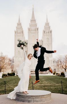 a bride and groom jumping in front of the salt lake temple during their wedding day