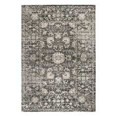 a gray and white rug with an ornate design on the bottom, in front of a white background