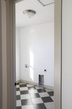 an empty room with a black and white checkered floor