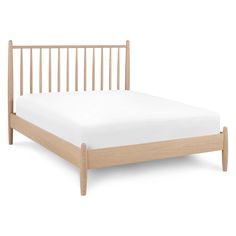 a wooden bed frame with white sheets on it and no headboard or foot board