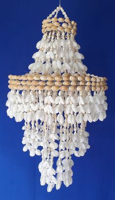 a chandelier made out of shells and wood beads