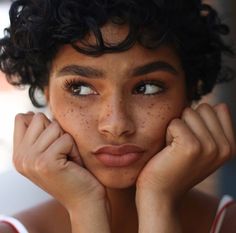 an image of a woman with freckles on her face looking at the camera