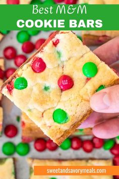 a hand holding the best m&m cookie bar