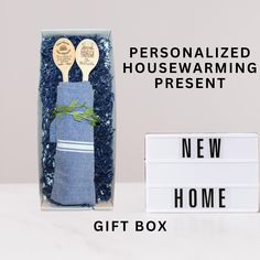 two wooden spoons in a gift box with the words personalized housewarming present