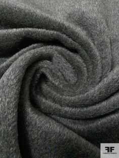 a close up shot of a grey fabric textured with wool flannel yarn