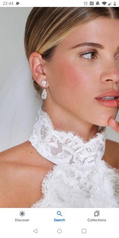 a woman in a wedding dress is holding her nose