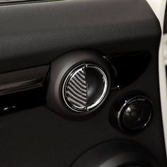 the interior of a car with an automatic gear stick and steering wheel cover in black leather