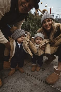 a woman and two children wearing winter clothes