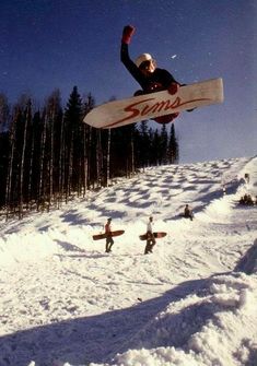 a man flying through the air while riding skis on top of snow covered ground