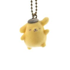 a yellow stuffed animal with a hat on it's head is hanging from a ball chain