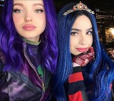 two women with blue and purple hair posing for the camera