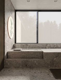 a bath room with a large window next to a sink and a tub in front of it