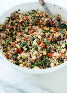 a white bowl filled with rice and vegetables