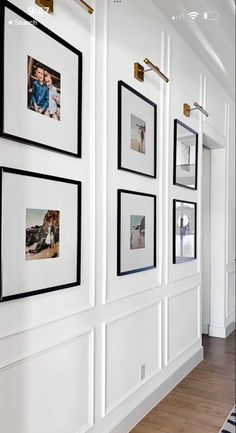 a room with white walls and pictures on the wall