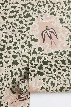 a pink and green wallpaper with an abstract design on the front, back and side