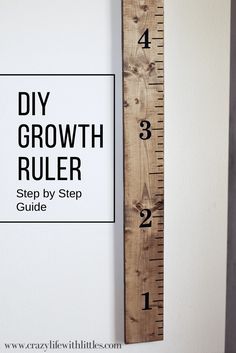 a wooden ruler with the words diy growth ruler on it next to a white wall