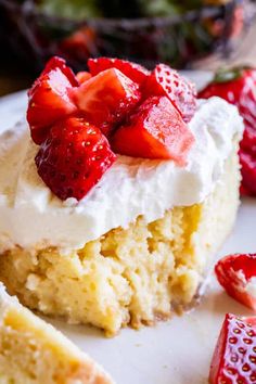 a piece of cake with whipped cream and strawberries on top