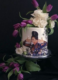 a cake decorated with flowers and photos on it