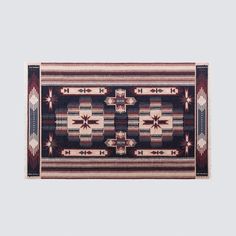 an area rug is shown with red and black designs on the border, along with white background