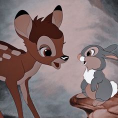 the little deer and the rabbit are standing next to each other