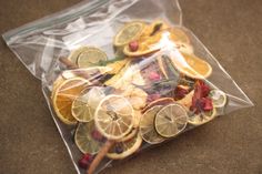 a bag filled with oranges and other fruits