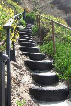 a set of steps made out of tires on the side of a hill