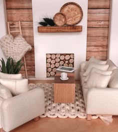 a living room with two white couches and a coffee table in front of a wooden wall