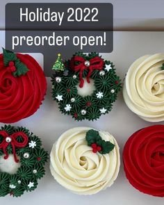 four cupcakes decorated with holly wreaths and bows