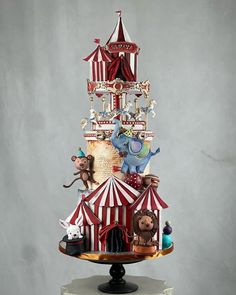 a circus themed cake with animals on top