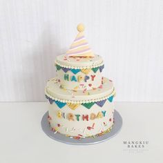 a three tiered birthday cake on top of a table