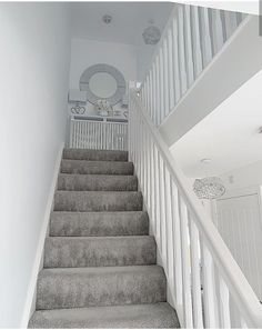 the stairs are lined with carpet and white railings