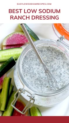 a bowl filled with ranch dressing next to sliced cucumbers and pickles on a white plate