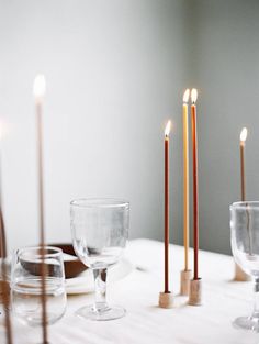 a table with candles and dishes on it