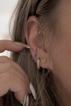 Girl wearing mini hoop earrings and butterfly studs Gold Minimalist Earrings With Butterfly Charm, Minimalist Gold Earrings With Butterfly Charm, Everyday Gold Butterfly-shaped Jewelry, Gold Huggie Earrings With Butterfly Charm, Gold Earrings With Butterfly Charm For Everyday, Earrings Stack, Stacking Earrings, Small Stud Earrings, Earrings Butterfly