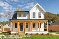 a white two story house sitting on top of a lush green field