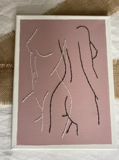 a piece of art that looks like a woman's body on a pink background