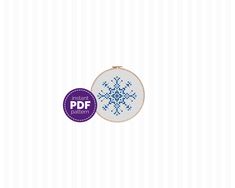 a cross stitch snowflake pattern with the words instant pattern in purple and white