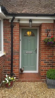 a green front door on a brick house