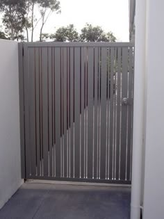 an open gate in the corner of a building