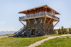 a stone building on top of a hill with stairs leading to the upper floor and second story