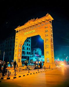 people are standing in front of an illuminated archway