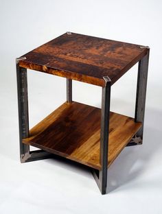 a wooden table with metal frame and shelf on the bottom, against a white background