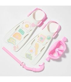 two pieces of plastic with pink handles and spoons next to each other on a white surface