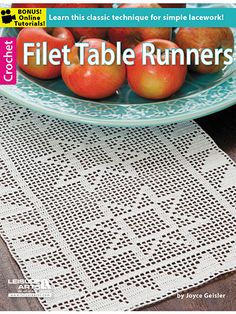 a plate with some apples on top of it next to a doily table runner